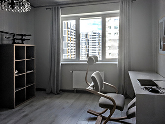 Study room is dominated by a vintage Danish modern chair and large white glossy desk, the rest is mainly hues of gray.