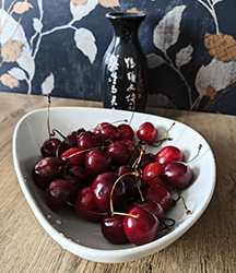 Round red cherries and sake bottle to set the mood for Japan.